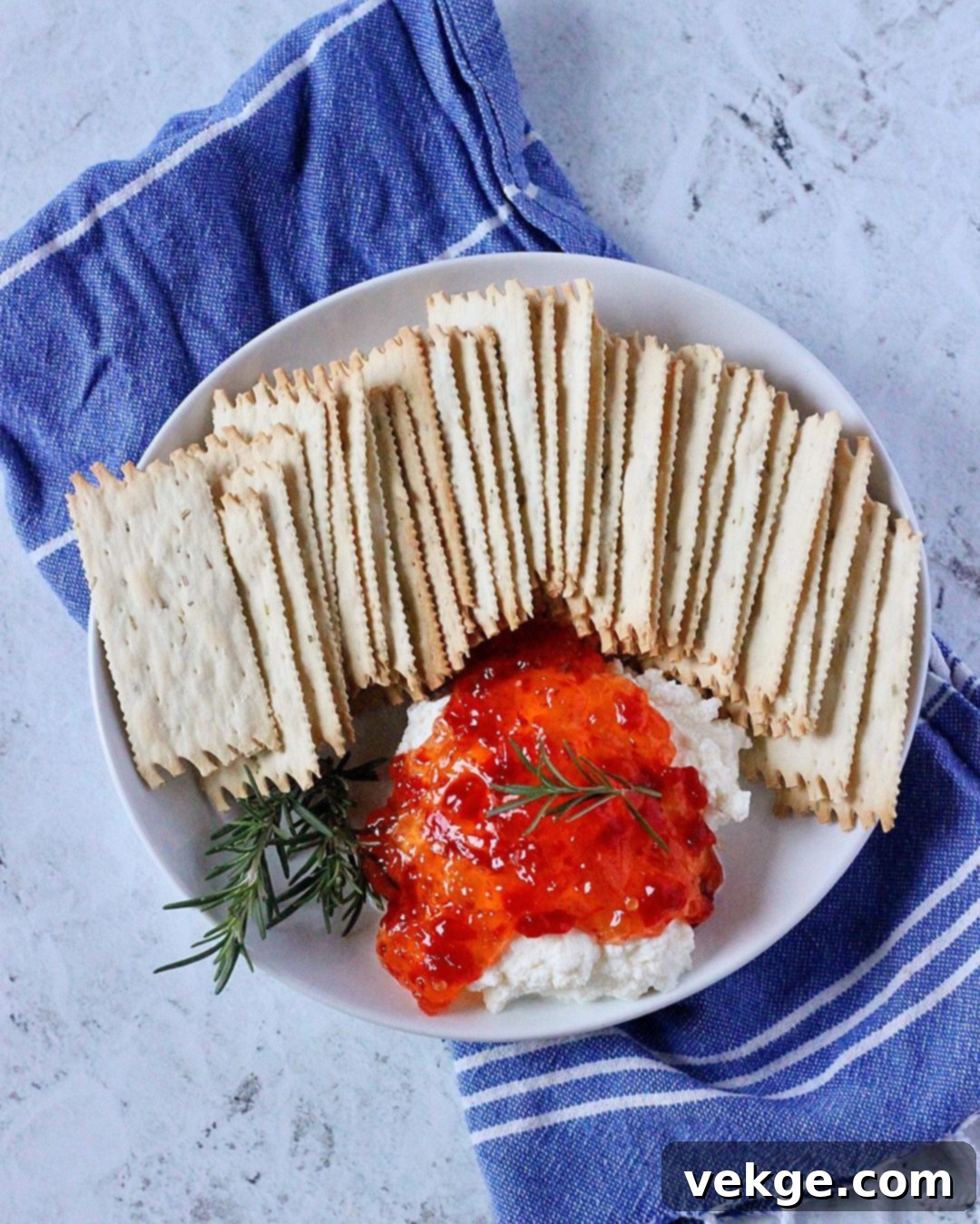 Sweet Heat Cheese Board 6 A simple yet elegant presentation of the sweet and hot jelly, ricotta, and rosemary cracker appetizer, ready to be enjoyed.