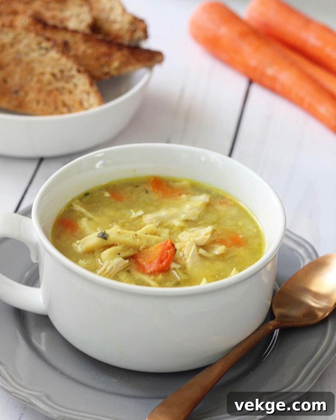 A steaming bowl of Instant Pot Chicken Noodle Soup garnished with fresh parsley.
