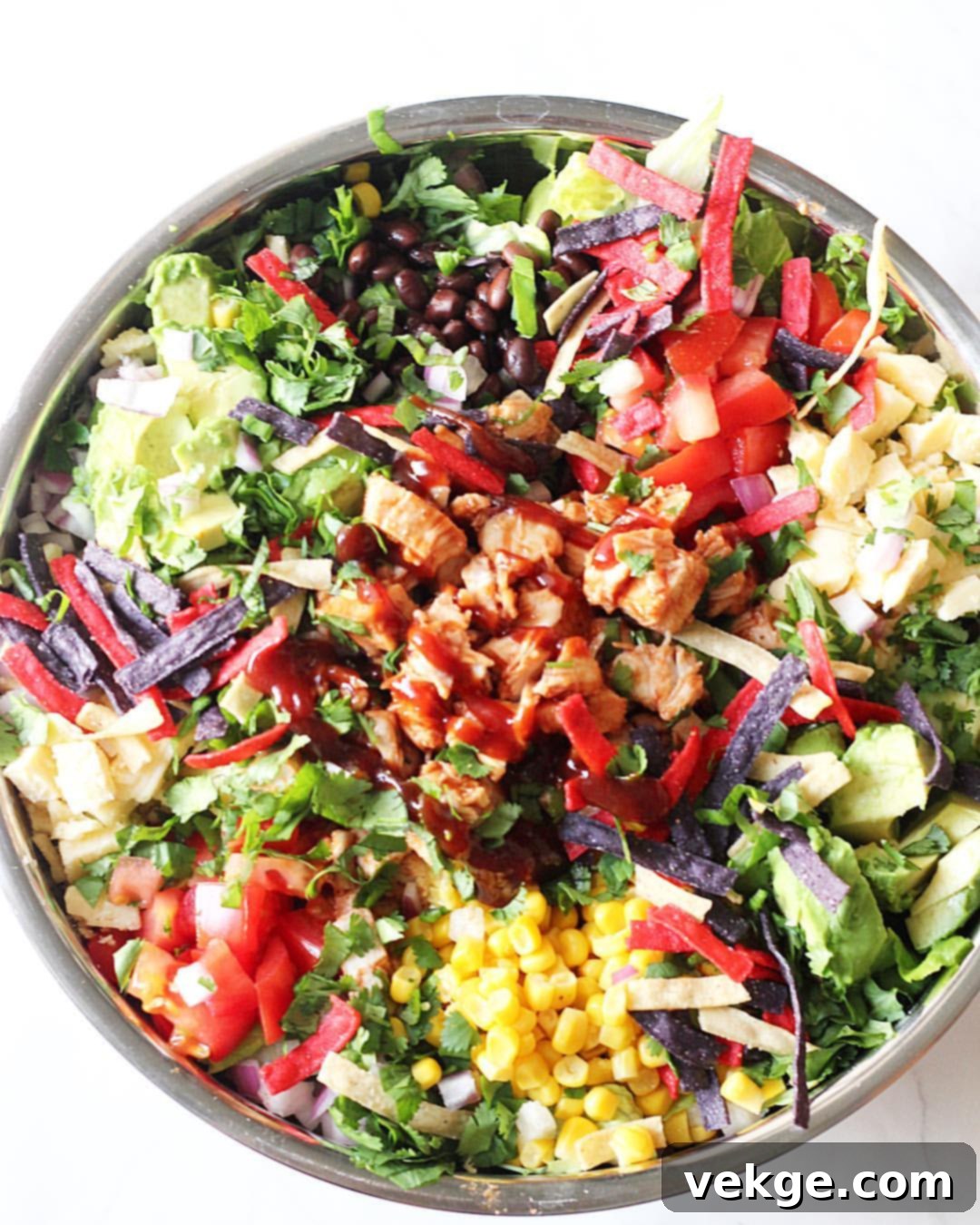 Smoky BBQ Chicken Salad 2 A vibrant BBQ Chicken Salad in a clear to-go container with a side of dressing, ideal for packed lunches.