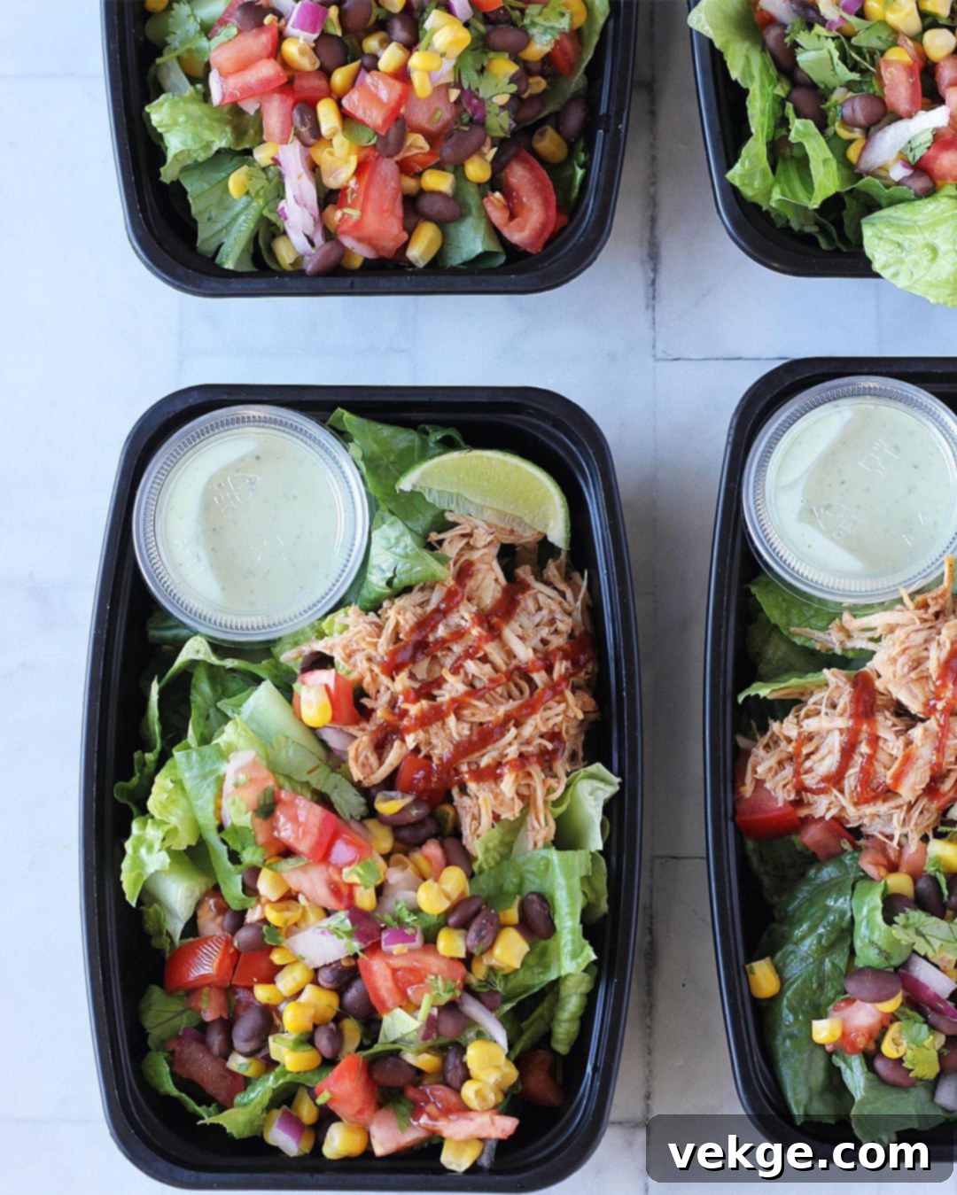 Smoky BBQ Chicken Salad 3 Assorted meal prep containers filled with BBQ chicken salad ingredients, along with small dressing cups, ready for packed lunches.