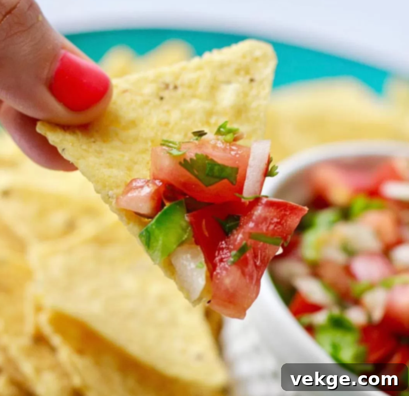 Perfect Homemade Pico de Gallo 4 A beautifully presented bowl of homemade Pico de Gallo, garnished with fresh cilantro, ready to be served.