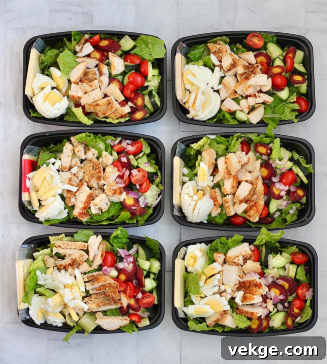 Various prepped salads in meal prep containers