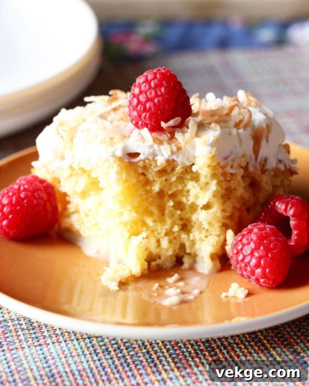 A beautifully decorated Coconut Tres Leches Cake, showcasing its moist texture and creamy topping