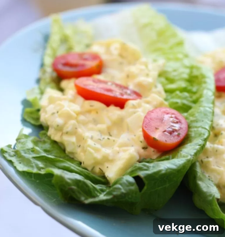 Perfect Egg Salad 4 A close-up image of a bowl of creamy egg salad with fresh dill garnish.