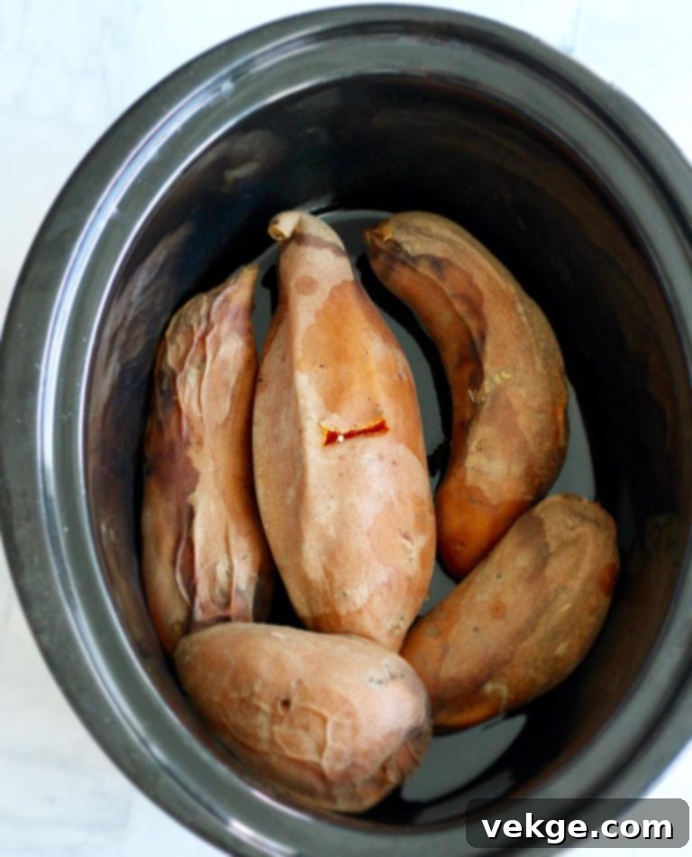 Crockpot Baked Potatoes 2 Sweet potatoes in a slow cooker, ready for baking