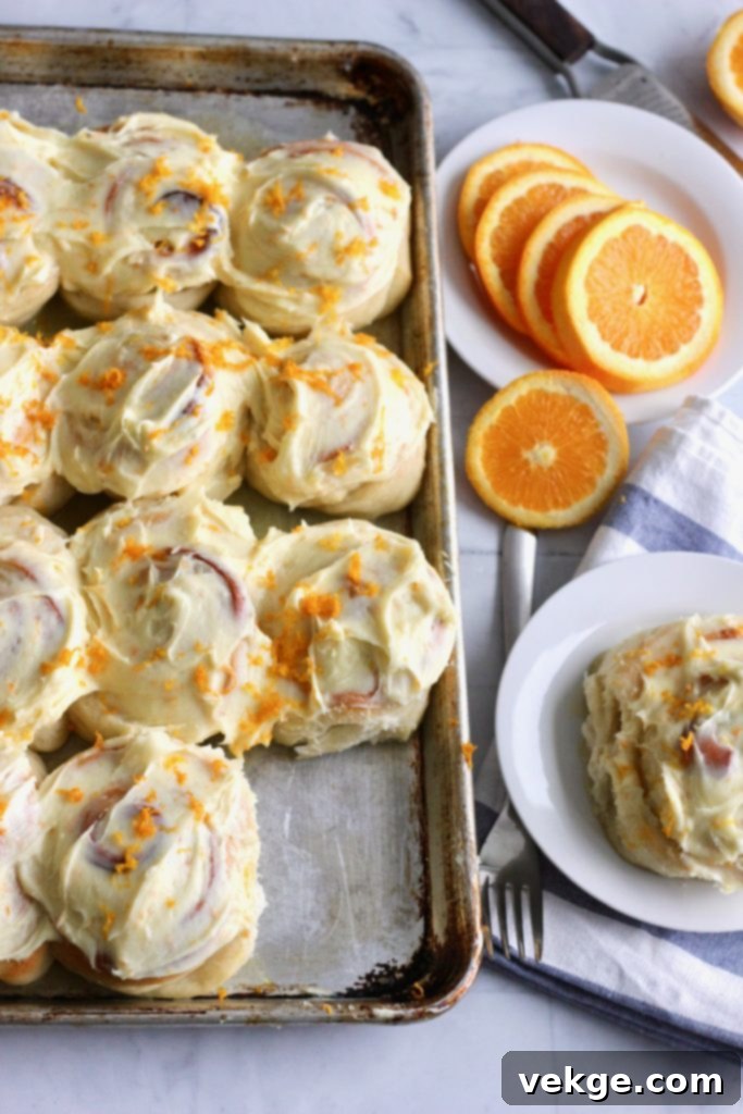 Beautifully baked sourdough orange rolls with a citrus glaze.