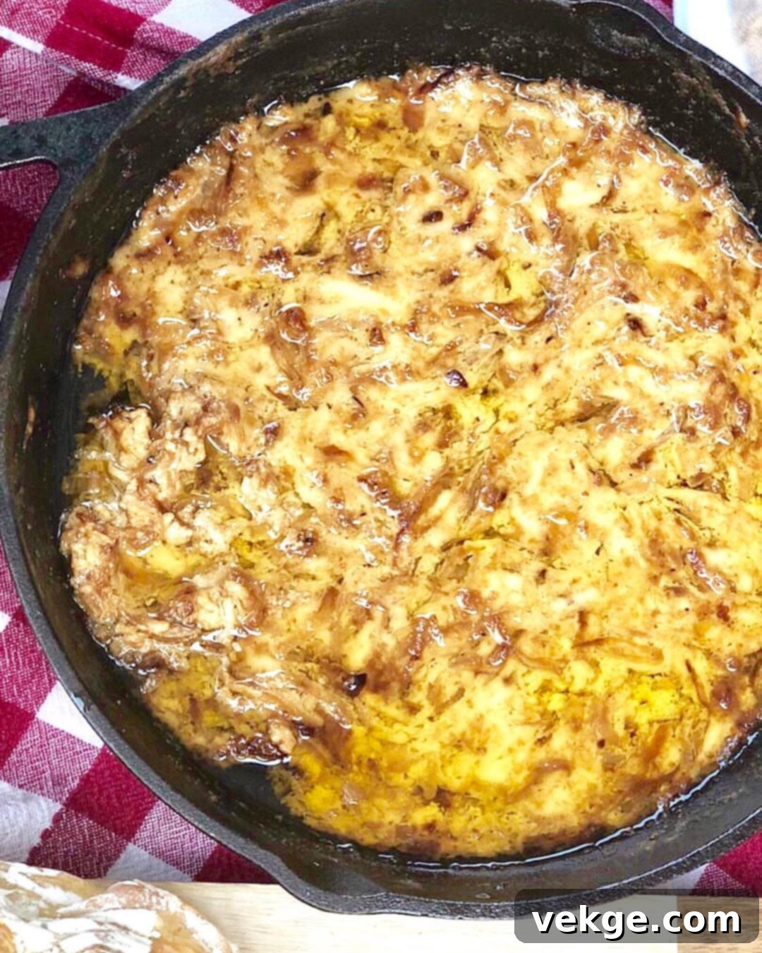 Golden Onion Gruyere Bliss 2 Close-up of golden brown caramelized onions simmering in a cast iron skillet, a key ingredient for the dip.