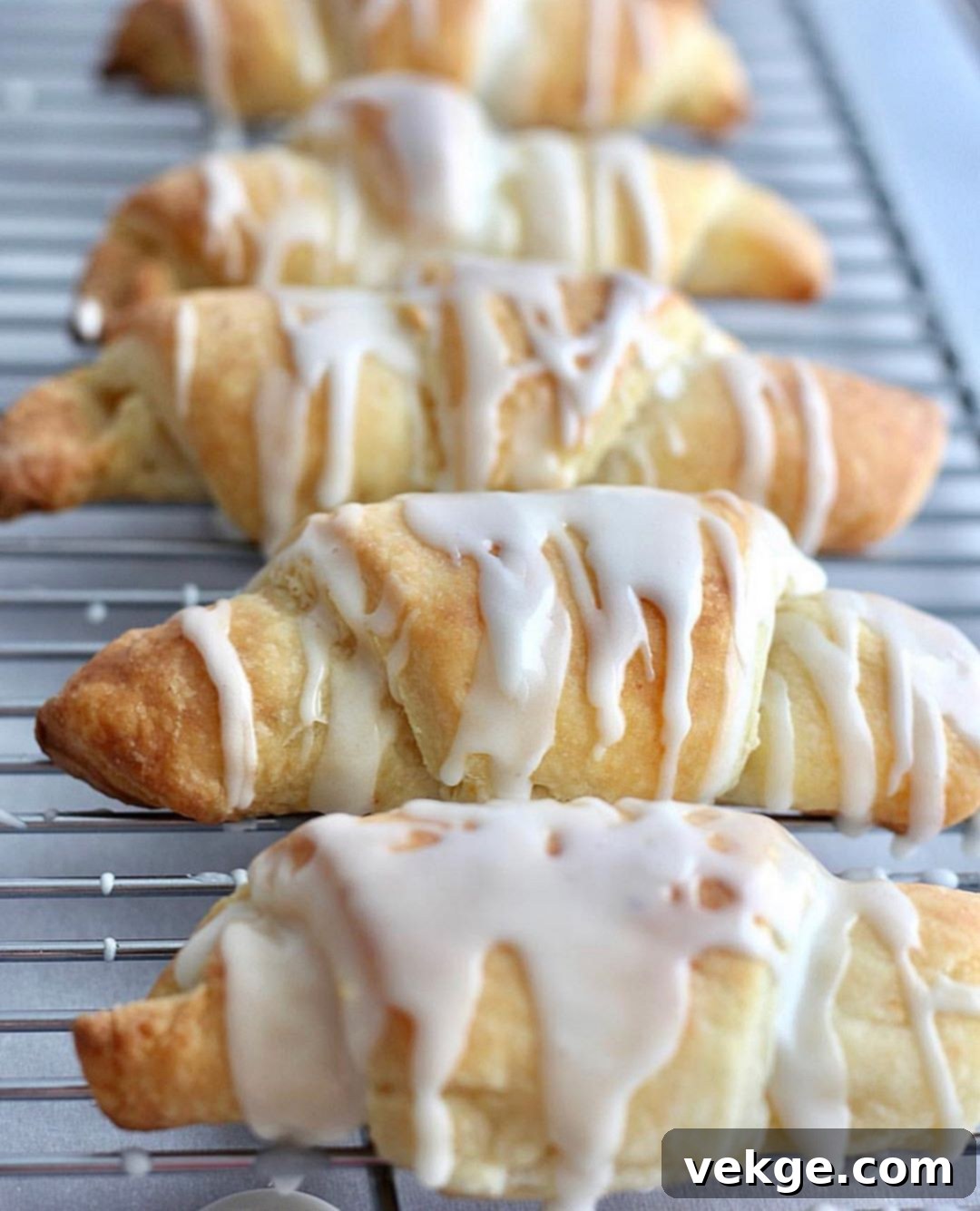 Melt-in-Your-Mouth Cheese Puffs 2 Freshly baked flaky buttery cheese rolls on a baking sheet, golden brown and tempting.