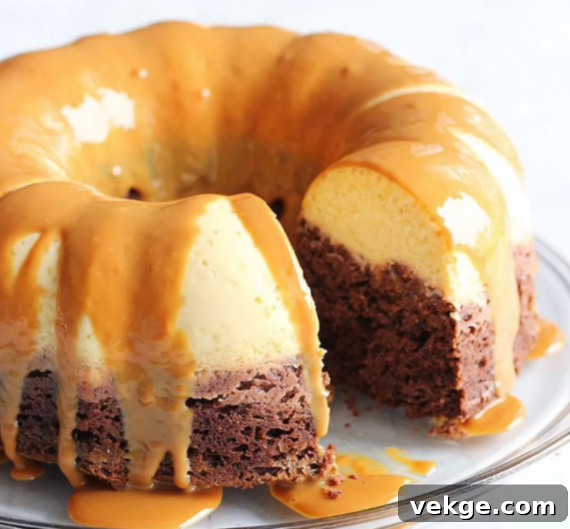 The Impossible Cake 4 Close-up of a Chocoflan slice, revealing the rich chocolate cake layer below the creamy flan layer, all topped with dulce de leche.