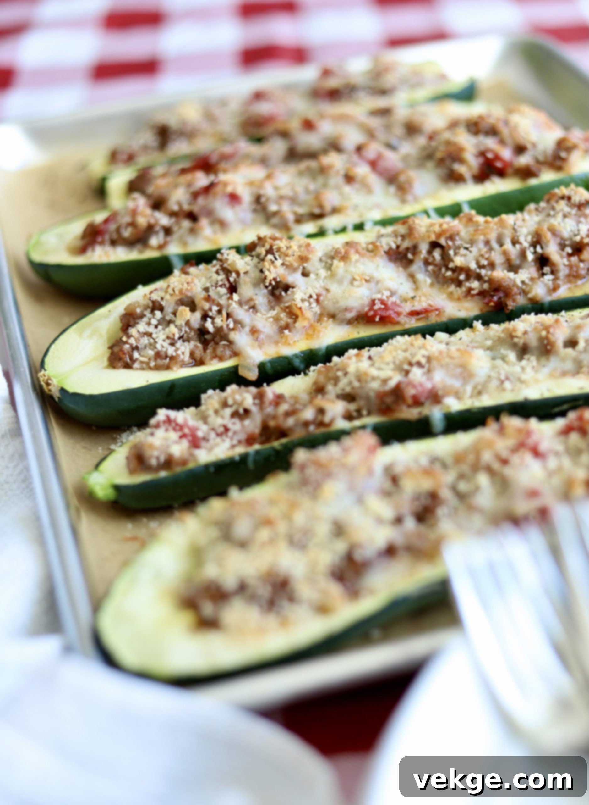 Loaded Zucchini Boats 3 Close-up of a perfectly cooked Stuffed Zucchini Boat showing the rich sausage and cheese filling