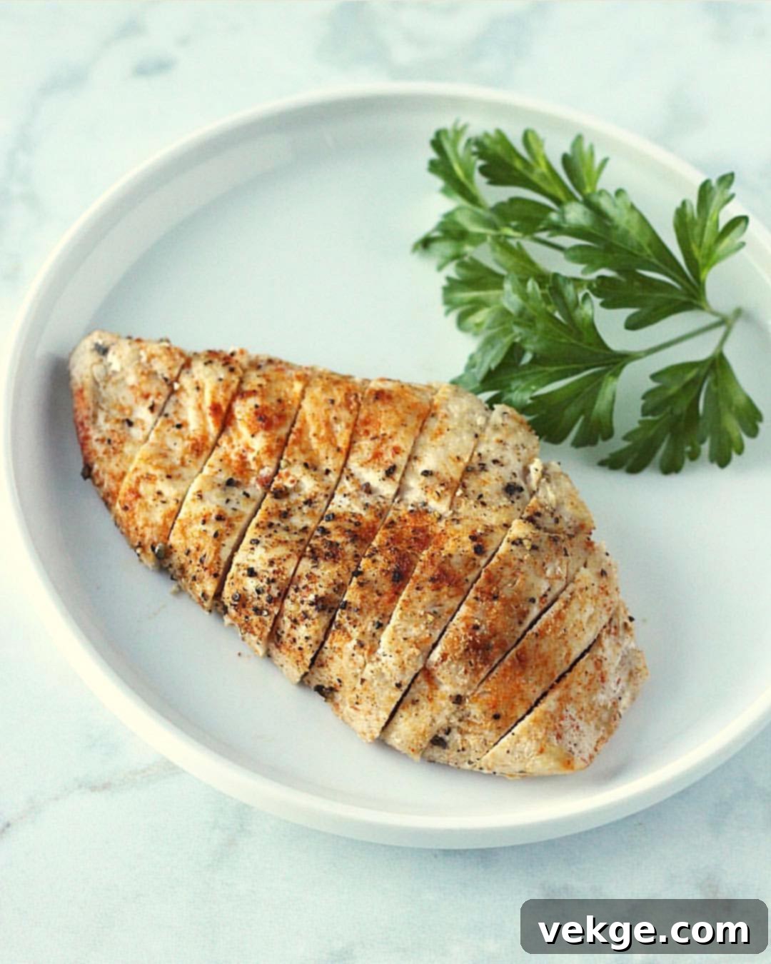 Beautifully baked chicken breast, golden brown and juicy, served with herbs.