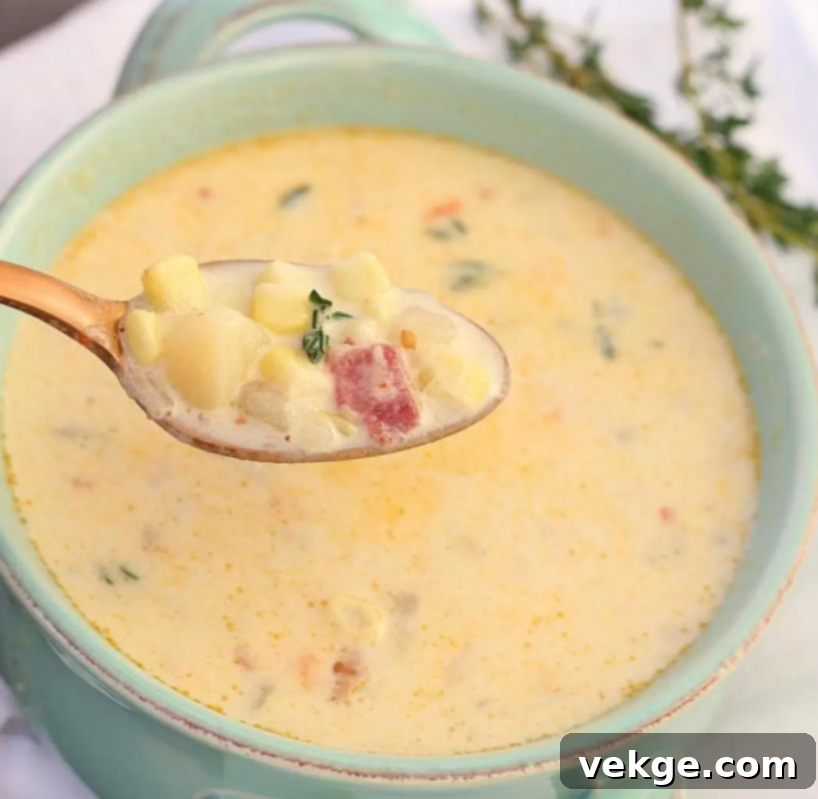 A bowl of creamy Instant Pot Corn Chowder, garnished with fresh thyme and crispy bacon.
