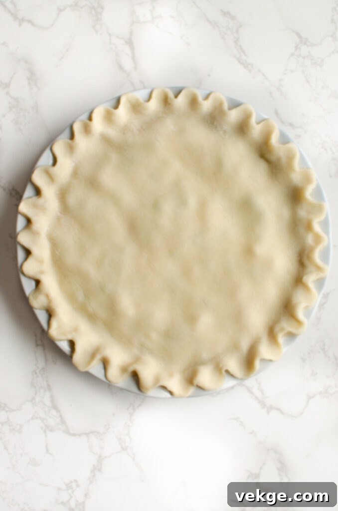 Ultimate Weeknight Chicken Pot Pie 8 Crimping the edges of a chicken pot pie