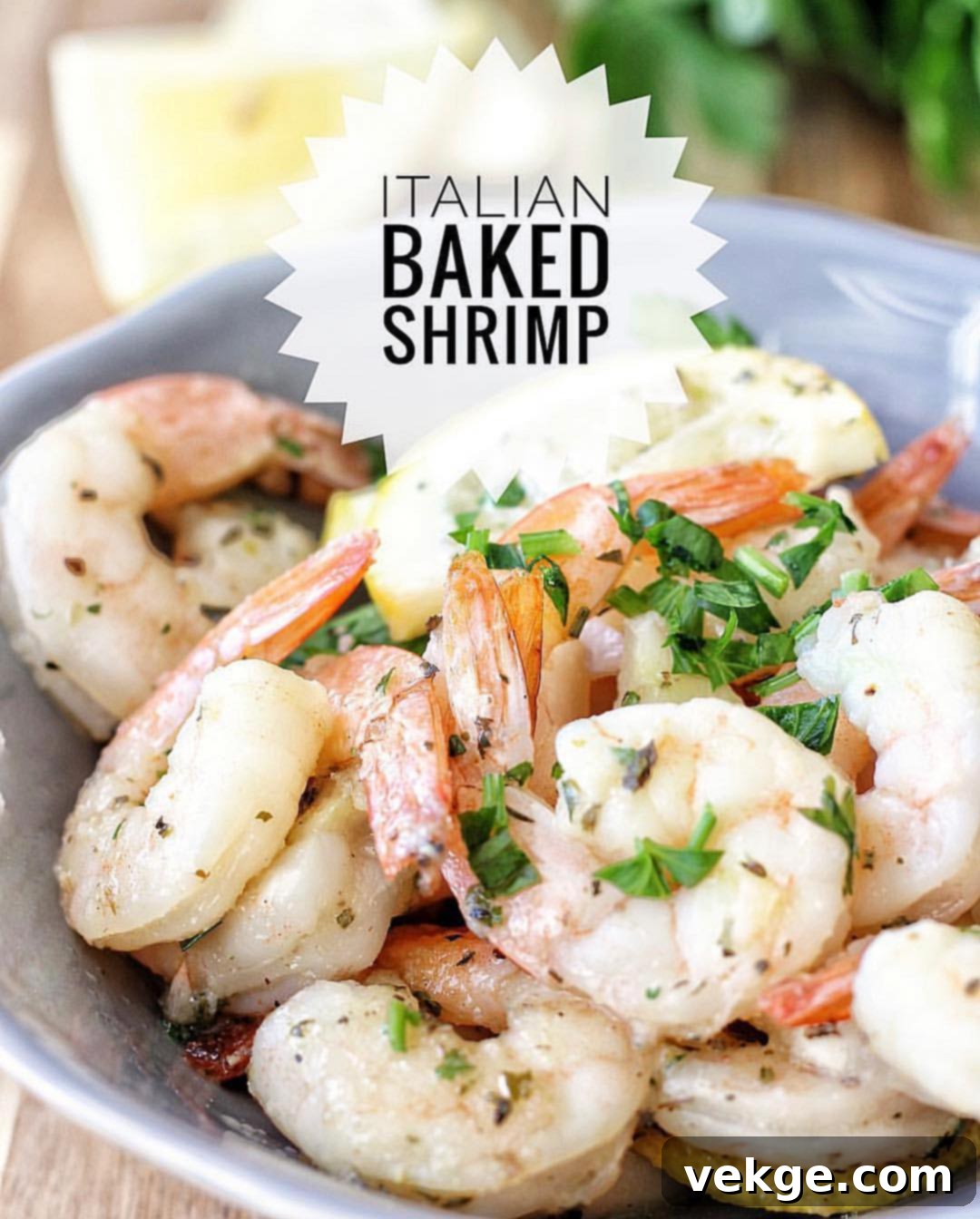 Close-up of baked Italian shrimp with lemon and herbs in a pan.