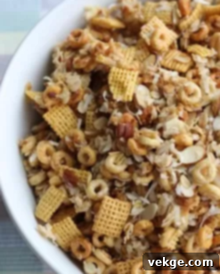 A close-up of a bowl filled with Christmas Crack, with a festive background.