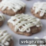 Golden Harvest Cookie Delights 6 A stack of beautifully frosted Festive Fall Cookies, garnished with a sprinkle of cinnamon, ready to be enjoyed.