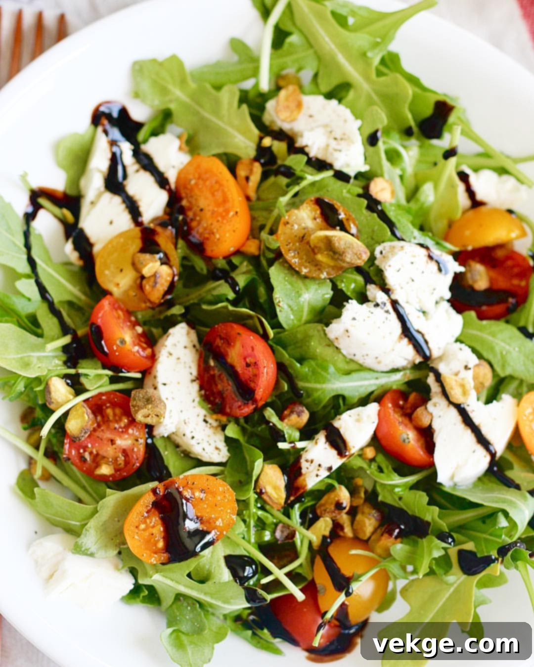 Elevated Arugula Pistachio Caprese 2 Fresh Arugula and Pistachio Caprese Salad with Cherry Tomatoes and Mozzarella