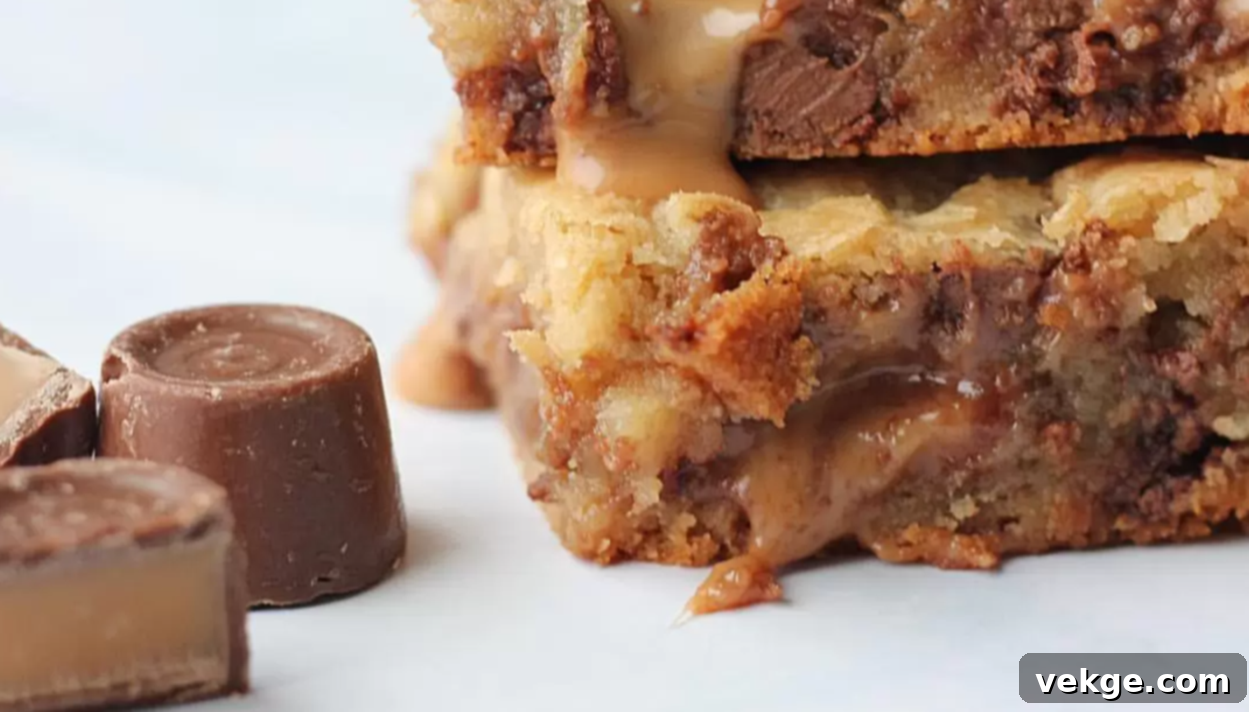 Golden Rolo Caramel Blondies 4 Rolo Stuffed Blondies with a visible melted caramel center after being cut.