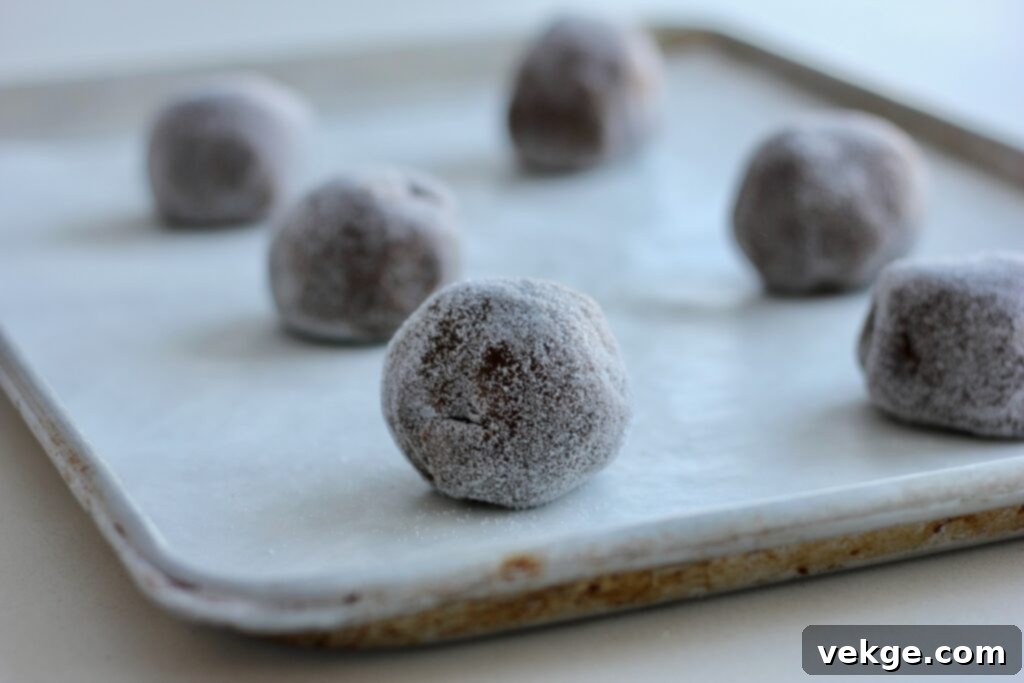 Toasted Butter Sourdough Molasses Gems 7 Close-up of a perfectly baked browned butter sourdough molasses cookie on a wooden surface, showing its soft interior