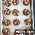 Gooey Smores Chocolate Chunk Cookies 4 Several S'mores cookies artfully arranged on a wooden board, showcasing their rich texture.