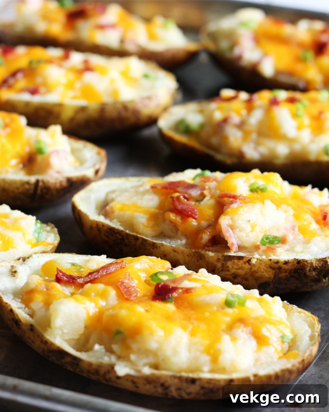 Double-Baked Delight 2 Delicious golden brown twice-baked potatoes garnished with fresh green onions and crispy bacon bits, ready to be served.