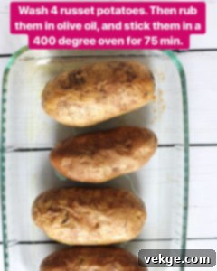 Double-Baked Delight 3 Washing four russet potatoes thoroughly under running water, preparing them for the first bake.