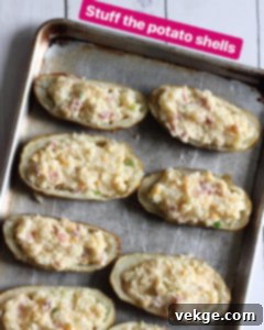 Double-Baked Delight 7 Scooping out the fluffy potato flesh from the baked skins, leaving a sturdy shell.