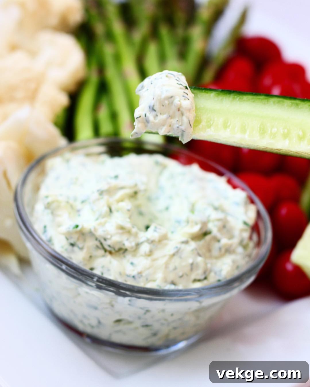 Vibrant Veggie Dip 3 Close-up of the creamy homemade veggie dip in a white bowl, garnished with fresh dill and surrounded by sliced green onions.