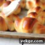 Irresistible Dinner Rolls 4 A plate of golden brown, delicious dinner rolls ready to be served.