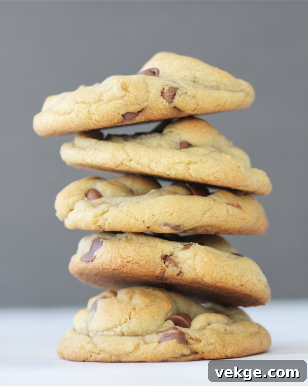 Mighty Chocolate Chip Monsters 2 Deliciously thick chocolate chip cookie on a cooling rack, showcasing its impressive height and golden-brown edges.