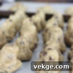 Mighty Chocolate Chip Monsters 3 Close-up of a homemade thick chocolate chip cookie, highlighting its rich texture and abundant chocolate chips.