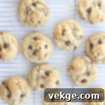 Mighty Chocolate Chip Monsters 4 A stack of three oversized chocolate chip cookies, demonstrating their substantial thickness and golden-brown perfection.