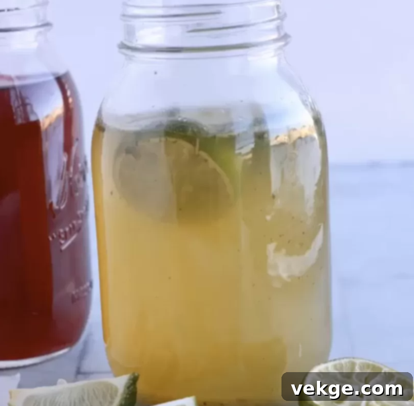 Sparkling Gut Elixir 4 Freshly prepared water kefir in a glass jar, showing a light, clear liquid with a slight fizz.