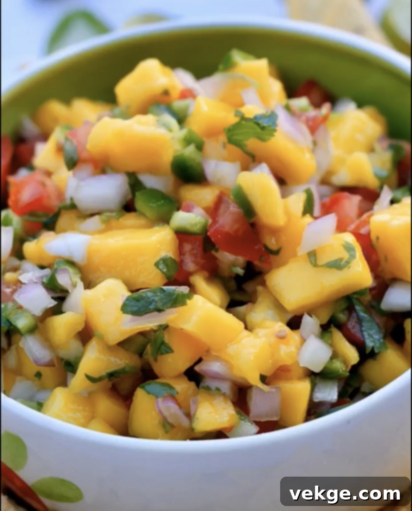 Vibrant Mango Salsa 2 Freshly prepared mango salsa in a bowl with tortilla chips.
