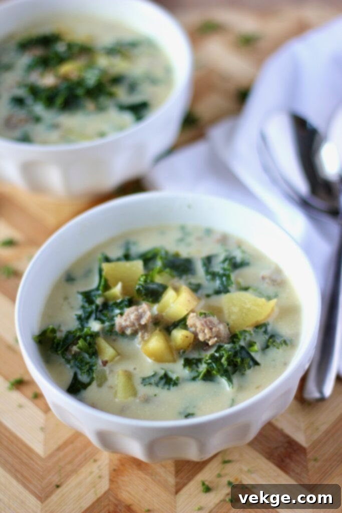 A bowl of Zuppa Toscana with a focus on its creamy texture and fresh ingredients.