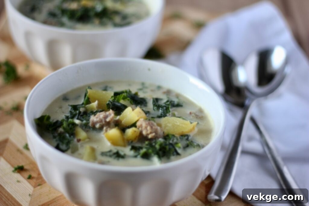 Close-up of a rustic wooden bowl filled with Zuppa Toscana soup, ready to be served.