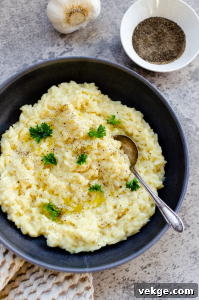 Effortless Instant Pot Risotto 2 Close-up of creamy Instant Pot Risotto in a white bowl, garnished with fresh herbs and Parmesan