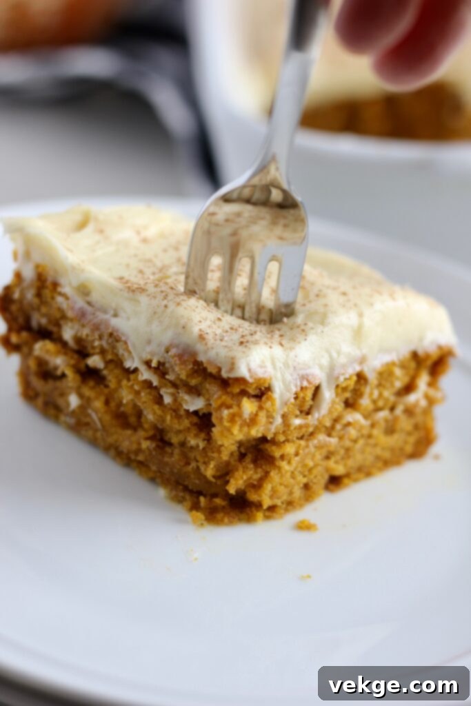 Perfectly cut pumpkin bars generously topped with cream cheese frosting
