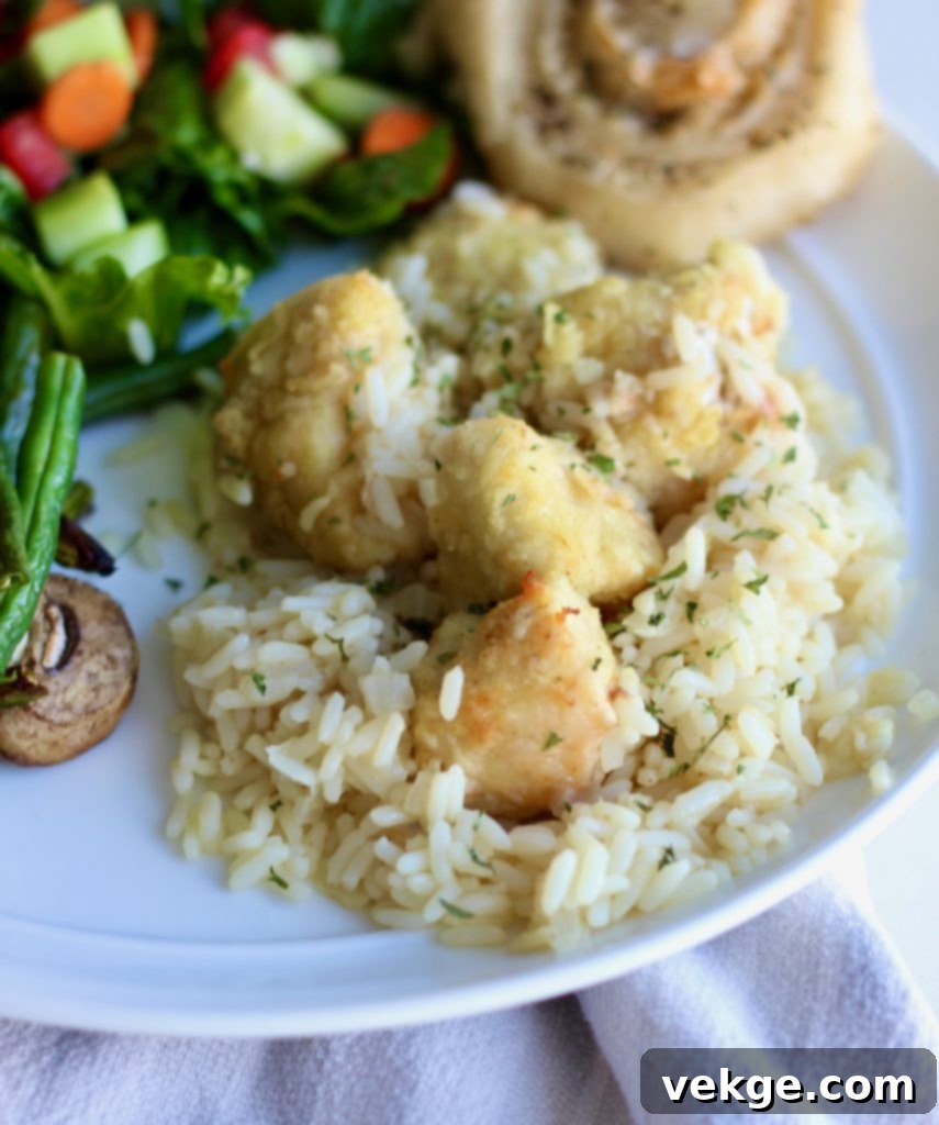 Ultimate Baked Chicken and Rice 11 A serving of baked chicken and rice, garnished with fresh herbs