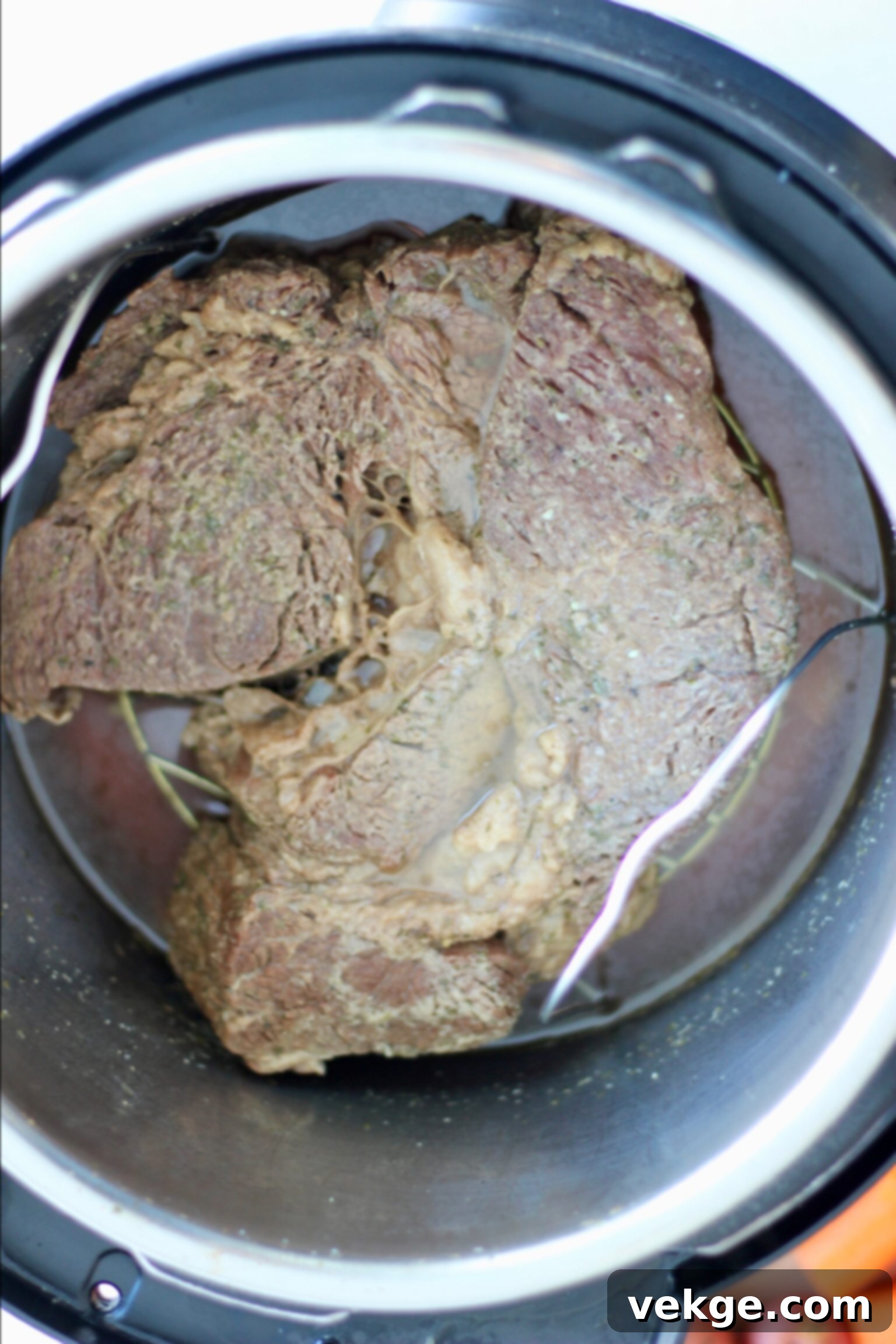 Chuck roast on a trivet in Instant Pot with broth