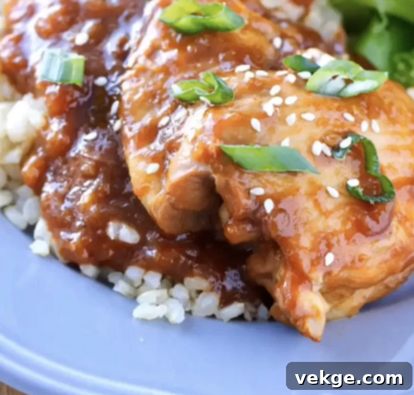 Sweet and Tangy Instant Pot Pineapple Chicken 4 A vibrant Instant Pot Pineapple Chicken dish, garnished with green onions and sesame seeds, in a white bowl.