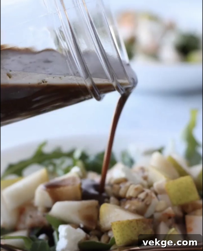 Gourmet Balsamic Vinaigrette 3 A close-up of a vibrant salad generously dressed with homemade balsamic vinaigrette, showcasing the glossy texture and fresh ingredients.