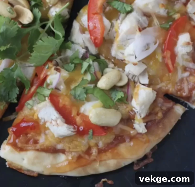 A vibrant Thai Chicken Pita Pizza, freshly baked and ready to be served.