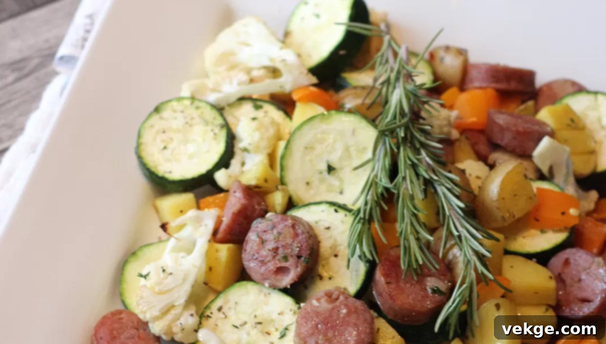 Sheet Pan Sausage and Veggies 9 One-pan roasted veggies and sausage cooking on a baking sheet.